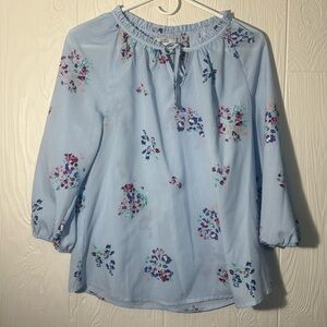 Blue and white striped blouse with flowers.
